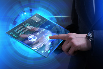 Business, Technology, Internet and network concept. Young businessman working on a virtual screen of the future and sees the inscription: Regulation