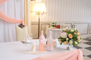 Beautiful wedding bouquet of roses and chrysanthemums in a metal vase on the diner table. Floral Wedding Decorations