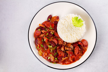 Red Beans with Sausages, Pancetta, Celery Stalks and Rice. View from above, top studio shot