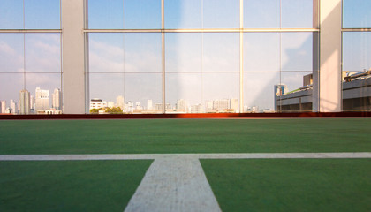 Fototapeta na wymiar Tennis Court On rooftop of the hotel building with sunrise shadow