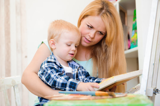 Mother and child draw a picture paints, art lesson