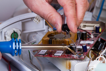 electrician fixing  electrical devices with different tools