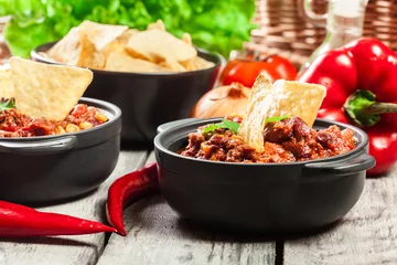 Fotobehang Bowls of hot chili con carne with ground beef, beans, tomatoes and corn © Sławomir Fajer
