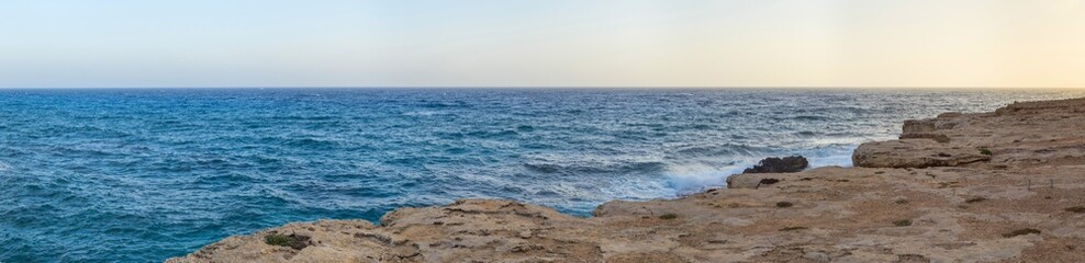 Naklejka na ściany i meble View on Mediterranean Sea from high rock bank at sunset. Cape Greko, Cyprus. 