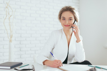 Portrait of beautiful young woman working in the office.