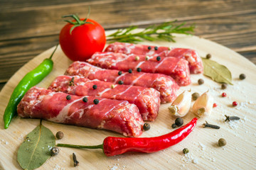 Raw cevapcici dish of mixed meats, the food of the Balkans. Minced meat and bacon.
