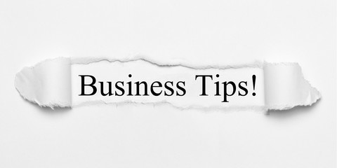 Business Tips! on white torn paper
