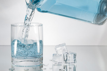 Decanter filling in glass of water splash