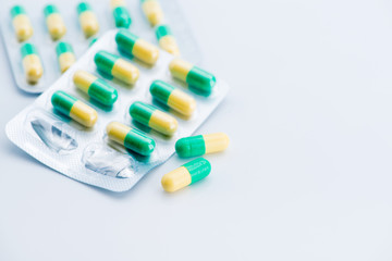 Pile of scattered capsules on a white background