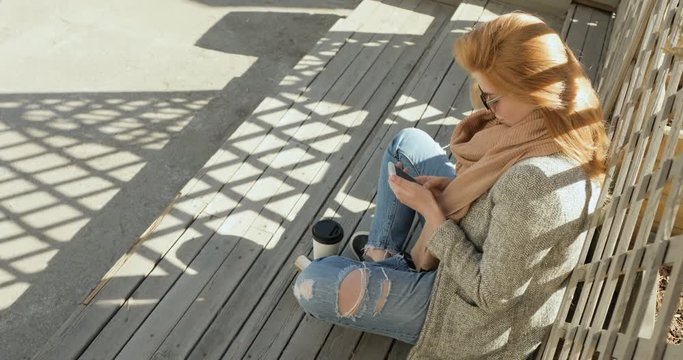 beautiful gitl texting on smartphone in the city