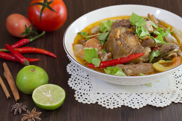 Oxtail soup in white bowl and vegetables for ingredient soup on wooden table Halal food