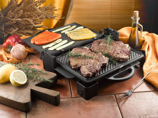 grilling some vegetables and steaks in the kitchen