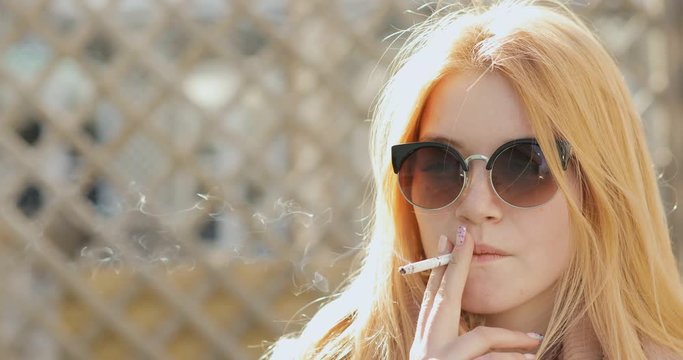 Beautiful young woman smoking