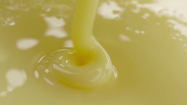 Pouring sweetened condensed milk. Close-up shot.
