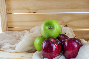 apples in a wooden box with a cheese cloth