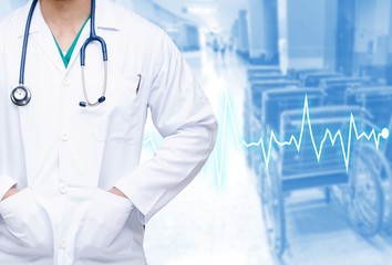 smart doctor with a stethoscope around his neck on blurred of wheelchair in hospital background with heartbeat line, color tone effect, concept of healthcare and medical, copy space