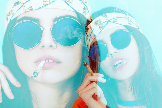 Double exposure of hippy girl smoking and wearing sunglasses