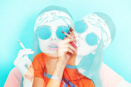 Double exposure of hippy girl portrait smoking weed while wearing sunglasses