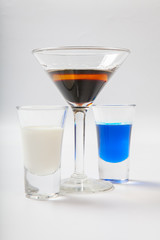 Several glasses of different drinks on bright background