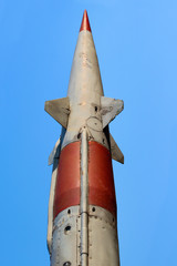 Old rocket missile on blue sky background