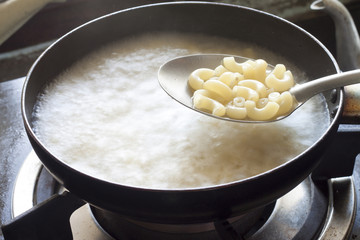 Boil macaroni in pan