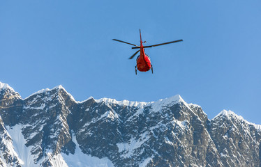 Helicopter on background of the Nuptse massif - Everest region, Nepal, Himalayas
