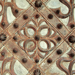 Rusty details and ornaments of wrought iron medieval door