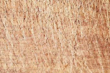 The texture of the surface of the wood with scratches.