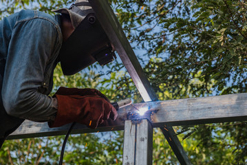 Welding steel by the male worker in industrial metal steel. - 144452723