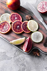 Sliced orange slices and lime on a wooden dovetail