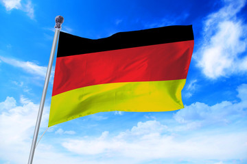 Flag of Germany developing against a clear blue sky