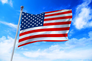 Obraz premium Flag of United States of America (USA) developing against a clear blue sky