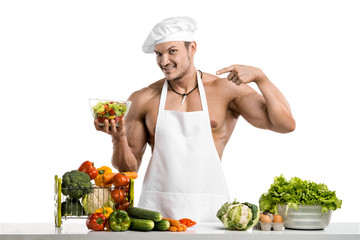 Man bodybuilder in white toque blanche and cook protective apron