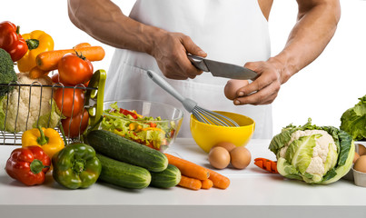 man hand cook make omelette, beating whisk eggs, on kitchen