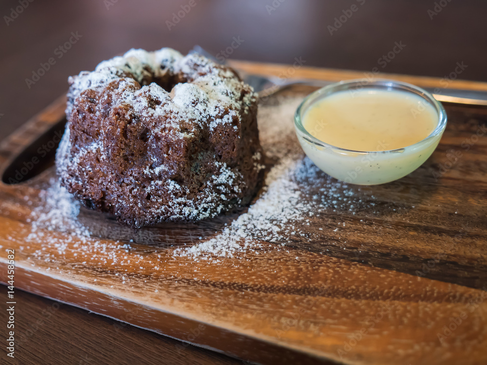 Wall mural sweet dessert, brown cake with milk cream sauce