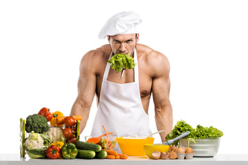 Man bodybuilder in white toque blanche and cook protective apron cooking cottage cheese and vegetables