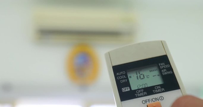 Cooling down room by changing temperature on air conditioner 4K 2160p UHD video - Changing room temperature with AC remote controller 4K 3840X2160 UHD footage