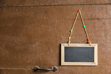 sign on a small chalkboard hanged to a wood door