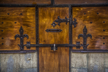 Wood medioeval ancient door with lock and friezes