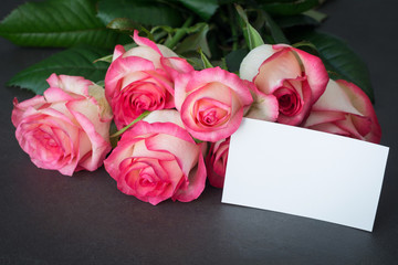 Bouquet of pink roses and empty tag with copy space. Closeup view. Mothers day, Women's day or other holidays gift mockup