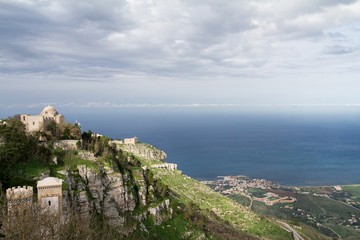 View of two old churches situated on Erice mountain, with the mediterranean sea in the background