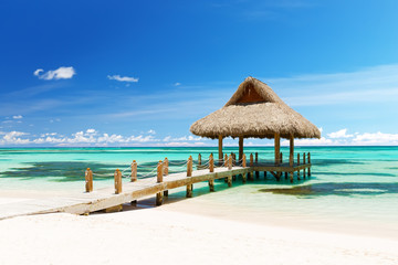 Beautiful gazebo on the tropical white sandy beach in Punta Cana, Dominican Republic - obrazy, fototapety, plakaty