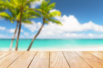 Wooden table top on blue sea and white sand beach