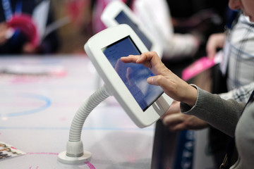 The hand of a woman when working with a touch screen