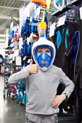 Boy in mask for scuba diving in sport shop