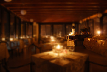 set tables of a restaurant by candlelight