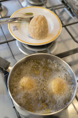  rice balls frying in boiling oil