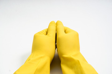 hands in yellow rubber gloves on white background