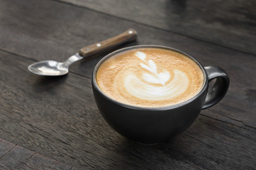 Latte art coffee on table.