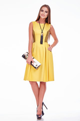 Beautiful sexy woman pretty face makeup wear fashion style clothes yellow wool dress accessory lather bag and shoes code glamour model office long brunette hair catalog trendy design